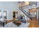 Comfortable living room featuring hardwood floors, a staircase and neutral decor at 945 Jones Wynd, Wake Forest, NC 27587
