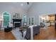 Bright living room with fireplace, hardwood floors, and backyard access at 945 Jones Wynd, Wake Forest, NC 27587