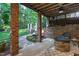 Inviting outdoor space featuring a stone patio with a fire pit and manicured landscaping at 945 Jones Wynd, Wake Forest, NC 27587