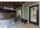 Covered patio with a brick fire pit, seating, and stylish decor for outdoor enjoyment at 945 Jones Wynd, Wake Forest, NC 27587