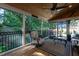Screened porch with wood ceiling, outdoor heater and cozy seating overlooking the backyard at 945 Jones Wynd, Wake Forest, NC 27587