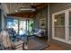 Covered porch with wood ceiling, ceiling fan, cozy seating and view to the back yard at 945 Jones Wynd, Wake Forest, NC 27587