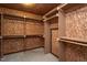 Large walk-in closet with custom shelving and hanging racks for efficient clothing organization at 945 Jones Wynd, Wake Forest, NC 27587