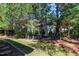 A beautiful backyard features lush green grass and mature shade trees at 9508 Vira Dr, Raleigh, NC 27617