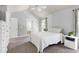 Bright bedroom with neutral decor, ceiling fan, and attached bathroom with a soaking tub at 9508 Vira Dr, Raleigh, NC 27617