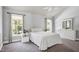 Bright bedroom with neutral decor, ceiling fan, and large windows with natural light at 9508 Vira Dr, Raleigh, NC 27617