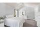 Bedroom with a white ceiling fan, white bedspread, and a white dresser at 9508 Vira Dr, Raleigh, NC 27617