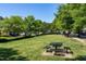 Community common area with a picnic table and mature landscaping at 9508 Vira Dr, Raleigh, NC 27617