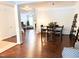 An open concept dining room with wood floors, a dining table with six chairs, and access to the living room at 9508 Vira Dr, Raleigh, NC 27617