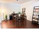 Dining room with a dark wood table, chairs and ladder shelves with decor at 9508 Vira Dr, Raleigh, NC 27617