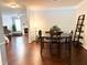 The dining room features wood floors and a table with six chairs, adjacent to the living room with a fireplace at 9508 Vira Dr, Raleigh, NC 27617