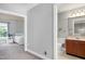 Hallway view of bathroom and bedroom with soft carpet, neutral colors, and recessed lighting at 9508 Vira Dr, Raleigh, NC 27617
