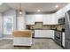 Bright kitchen featuring white cabinets, stainless steel appliances, tile backsplash, and a butcher block island at 9508 Vira Dr, Raleigh, NC 27617