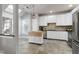 Bright kitchen featuring white cabinets, stainless steel appliances, a portable island, and skylights at 9508 Vira Dr, Raleigh, NC 27617