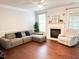Cozy living room with a fireplace, ample seating, and natural light from windows at 9508 Vira Dr, Raleigh, NC 27617