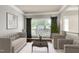 Bright living room featuring neutral tones, large windows, and elegant decor at 9508 Vira Dr, Raleigh, NC 27617