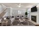 Bright living room featuring comfortable seating, fireplace, and a modern ceiling fan at 9508 Vira Dr, Raleigh, NC 27617