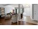 Open-concept living room with hardwood floors, elegant columns, and a welcoming foyer, perfect for entertaining and relaxation at 9508 Vira Dr, Raleigh, NC 27617