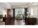 Well-lit office with dark wood furnishings, a large window, and ample storage at 9508 Vira Dr, Raleigh, NC 27617