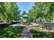 Neighborhood playground featuring playground equipment, picnic tables and surrounded by mature shade trees at 9508 Vira Dr, Raleigh, NC 27617