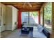 Comfortable screened porch with outdoor sectional, ceiling fan, and privacy curtains at 9508 Vira Dr, Raleigh, NC 27617