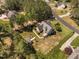 Aerial view shows a house with nice landscaping, surrounded by trees and other homes at 1006 Trumpet Vine Ct, Wendell, NC 27591