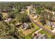 Aerial view showcases a home with a lush lawn, mature trees, and neighborhood surroundings at 1006 Trumpet Vine Ct, Wendell, NC 27591