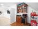 A bar area with a sink, microwave, mini-refrigerator, and custom wood cabinetry at 1006 Trumpet Vine Ct, Wendell, NC 27591