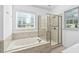 Bathroom featuring tiled walls, a glass-enclosed shower, and a soaking tub at 1006 Trumpet Vine Ct, Wendell, NC 27591