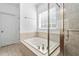 Bathroom with a tiled whirlpool tub and a glass enclosed shower at 1006 Trumpet Vine Ct, Wendell, NC 27591