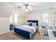 Stylish bedroom with a blue velvet bed, striped linens, and a comfortable sitting chair at 1006 Trumpet Vine Ct, Wendell, NC 27591