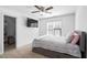 Cozy bedroom with a large window, ceiling fan, and wall-mounted television for relaxed living at 1006 Trumpet Vine Ct, Wendell, NC 27591