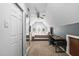 Bedroom with a ceiling fan and natural light, featuring a workspace and full-length mirror at 1006 Trumpet Vine Ct, Wendell, NC 27591
