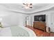 Bedroom with hardwood floors, tray ceiling, TV and ensuite; providing the ultimate comfort and style at 1006 Trumpet Vine Ct, Wendell, NC 27591