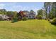 Charming home featuring a lush lawn and well-maintained landscaping with mature trees at 1006 Trumpet Vine Ct, Wendell, NC 27591