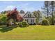 Charming home featuring a lush lawn and well-maintained landscaping with mature trees at 1006 Trumpet Vine Ct, Wendell, NC 27591