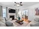 Inviting living room with a fireplace, plush seating, and view into dining area at 1006 Trumpet Vine Ct, Wendell, NC 27591