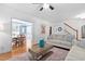 Open-concept living room with hardwood floors flowing into the dining room with blue accent wall at 1006 Trumpet Vine Ct, Wendell, NC 27591