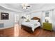 Primary bedroom with hardwood floors, tray ceiling, and an en-suite bathroom, complemented by stylish décor at 1006 Trumpet Vine Ct, Wendell, NC 27591