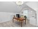 Bright home office with a wood desk, chandelier, and large window allowing plenty of natural light at 1006 Trumpet Vine Ct, Wendell, NC 27591
