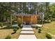 Outdoor pergola with a wooden plank backdrop, chairs, and a fire pit at 1006 Trumpet Vine Ct, Wendell, NC 27591
