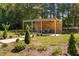 A covered backyard pergola with seating, a fire pit and manicured landscaping at 1006 Trumpet Vine Ct, Wendell, NC 27591
