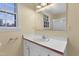 Bathroom view featuring vanity with window, mirror, updated lighting fixtures and neutral walls at 101 Atchison St, Garner, NC 27529