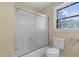 Bathroom showcasing a shower-tub, toilet, and window with natural light at 101 Atchison St, Garner, NC 27529