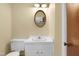 Bathroom vanity with framed mirror, vanity lighting, and neutral walls at 101 Atchison St, Garner, NC 27529