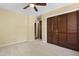 This bedroom features neutral carpet, a ceiling fan, and a closet with louvered doors at 101 Atchison St, Garner, NC 27529