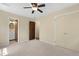 This carpeted bedroom offers a ceiling fan, closet space, and access to the bathroom at 101 Atchison St, Garner, NC 27529