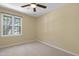 Neutral bedroom with plush carpet, a window, and a ceiling fan at 101 Atchison St, Garner, NC 27529