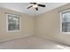 Bright bedroom with neutral carpet and two windows providing natural light and views at 101 Atchison St, Garner, NC 27529