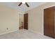 Bedroom with tan walls, carpet, and a door leading to the stairway at 101 Atchison St, Garner, NC 27529